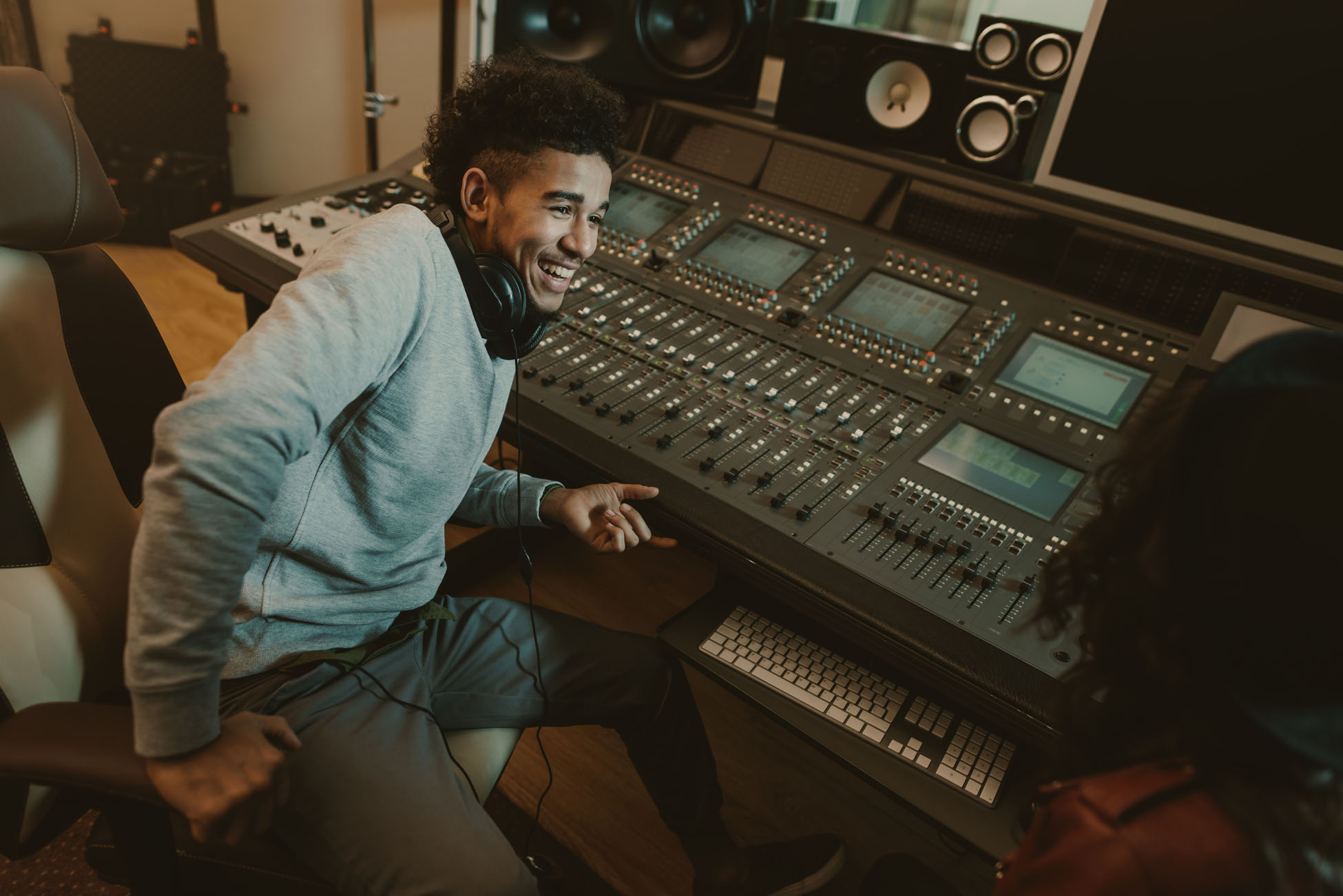 happy young sound producer sitting at studio happy young sound producer sitting at studio